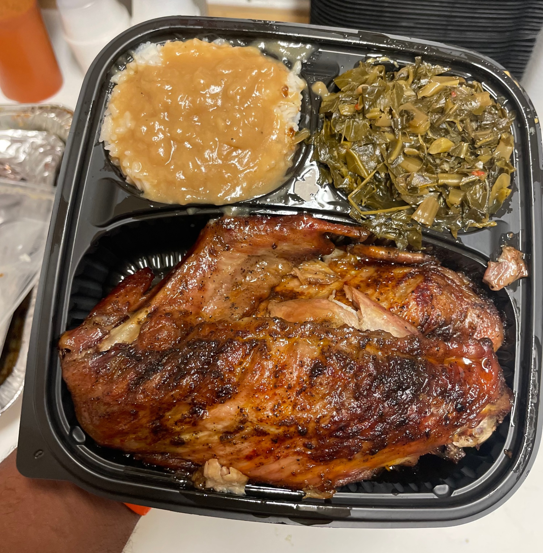 Dah's Kitchen turkey wing platter — jumbo smoked wings over rice with onion gravy and collard greens